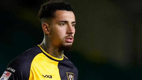 Courtney Baker-Richardson in action for Newport County in their black and yellow home shirt