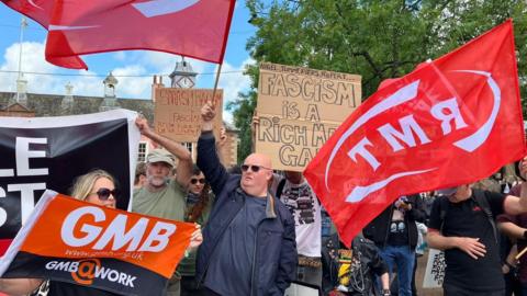 Anti-racism protesters waving banners and placards at Carlisle's Market Square