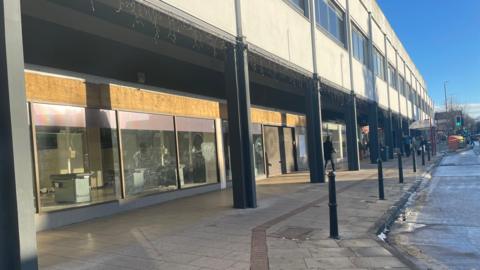 A photo of the vacant unit at Headingley Central. A till can be seen inside the store.