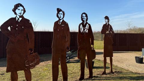 Image shows four of the steel silhouettes, commemorating 