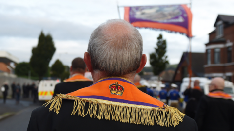 Back of head of an orange man in Ardoyne