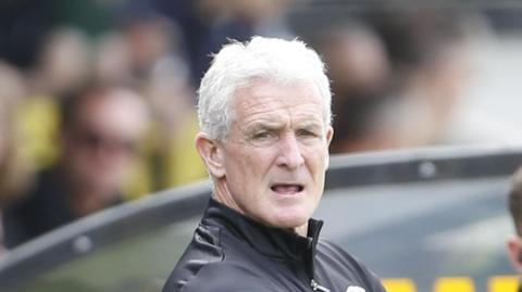 Mark Hughes watching a Carlisle match during pre-season