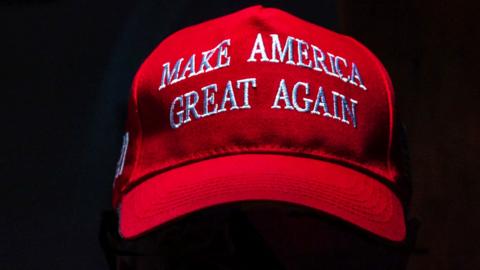 A red baseball cap with the slogan Make America Great Again printed on it