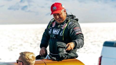 Chris Raschke wearing a read hat and a race suit