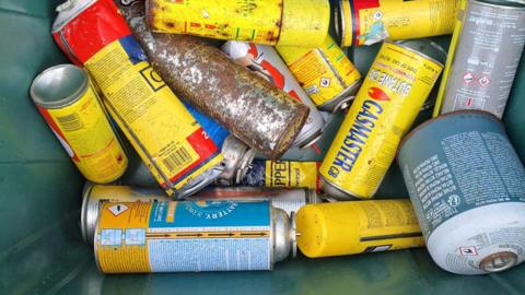 Gas canisters in a recycling box