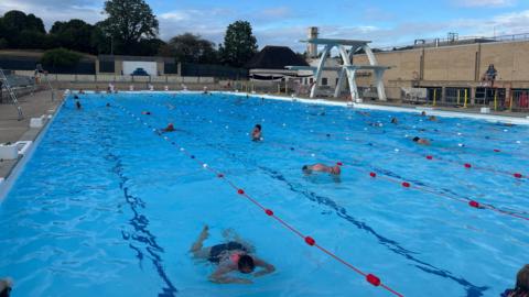 People swimming in lido.
