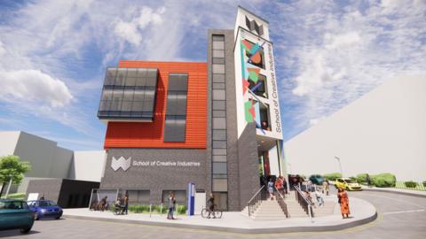 A computer-generated image shows a modern university building with dark grey brick and an orange-clad upper section. A tall tower feature on the right side displays colourful geometric artwork and the words 'School of Creative Industries' in vertical text. People are shown walking up steps to the entrance, with cars and bicycles parked nearby.
