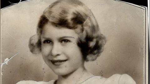 A black and white picture of young Queen Elizabeth II.
