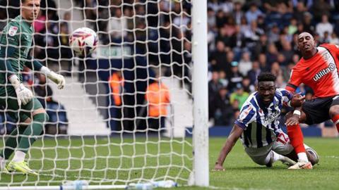 West Brom's Daryl Dike watches his first-half header hit the net against Luton