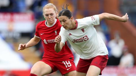Ceri Holland and Rachel Williams challenge for the ball