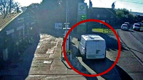White van parked on petrol forecourt next to fuel pump 