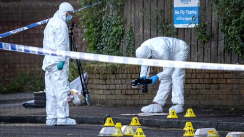 Police officers remain at the scene of a serious stabbing incident on Kinnaird Avenue in north Belfast on 9 June 2026.