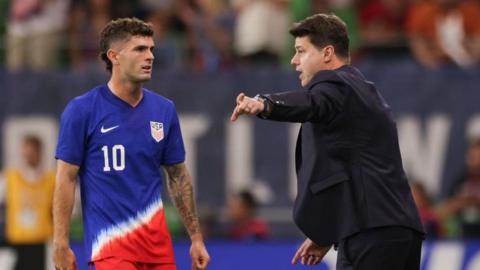 USA forward Christian Pulisic is given instructions by head coach Mauricio Pochettino