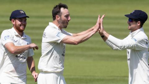 Toby Roland-Jones celebrates a wicket