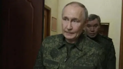 Vladimir Putin in military fatigues 