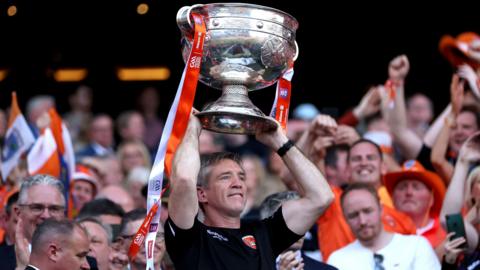 Kieran McGeeney holds the Sam Maguire Cup aloft at Croke Park