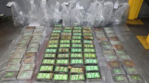 Numerous green parcels of cocaine, with clear plastic bags