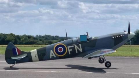 A side view of the Spitfire at takeoff, with its wheels a short height off the ground