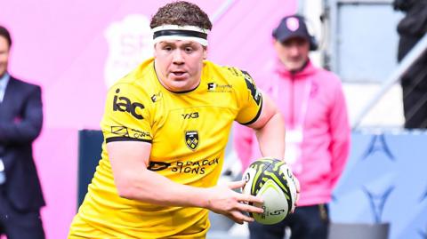 Brodie Coghlan in action with rugby hall in hand