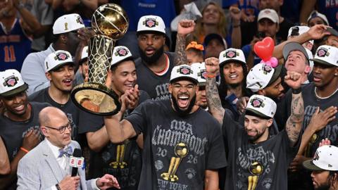 New York Knicks players holding the NBA Championship trophy