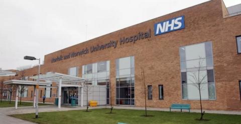 Part of the Norfolk and Norwich University Hospital. It is a large, brick building with the hospital's name along the top, large windows and a covered walkway to the door.