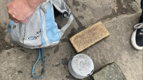 Brick and dumbbell and bag found with the dead dog