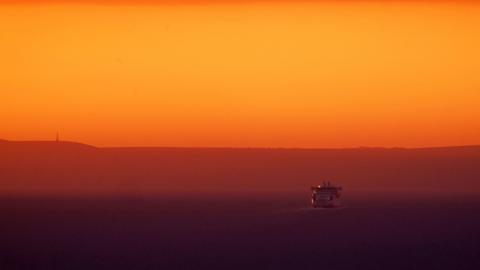 Ferry crosses the Channel towards France at sunrise following warmest February on record