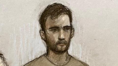 A court sketch of Mohammed Sharwarq, who has dark hair and a beard. He is wearing a light grey jumper.
