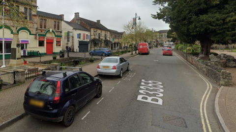 Cars parking on a High Street