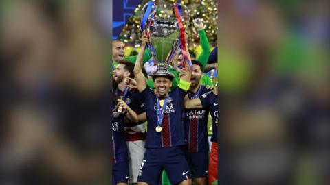 Marquinhos of PSG (C) and his teammates celebrate with the trophy