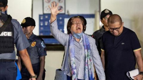  Former Philippines senator Leila de Lima waves as she walks out of the Philippine National Police custodial center after being granted bail following over six years in detention, at Quezon City, Philippines, November 13, 2023