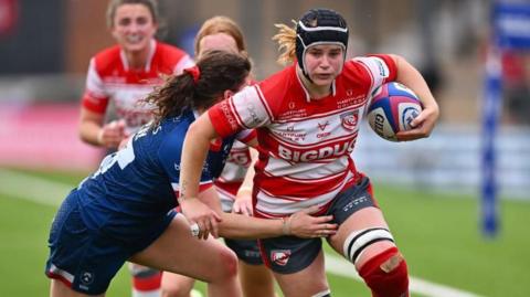 Bethan Lewis attempts to break a tackle