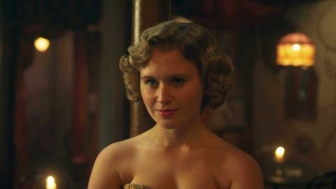 A woman looking to the left of the screen