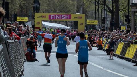 Runners approach the finish line of a half marathon