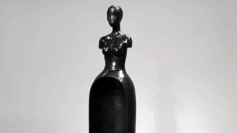 A black sculpture of a female torso by Simone Leigh