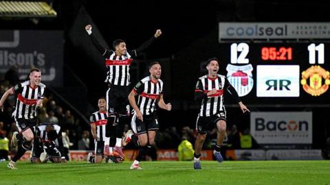 Grimsby Town players celebrating.