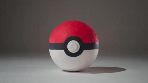 a plasticine version of the famous pokeball done in a classic aardman animations style on a plain background
