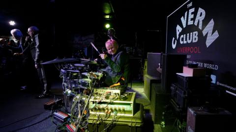 Zak Starkey, son of Sir Ringo Star, on drums performing with fellow band members (left to right) Shaun Ryder, Bez, Andy Bell of the Mantra of the Cosmos at The Cavern Club, Liverpool