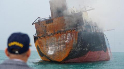 A foreign tanker carrying Iraqi fuel oil damaged after catching fire in Iraq's territorial waters, following unidentified attacks that targeted two foreign tankers, according to Iraqi port officials, near Basra, Iraq, March 12, 2026.