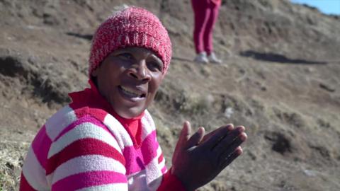 Women in pink hat looking at the camera