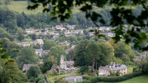 Stroud seen from a hill looking down at a church and houses.