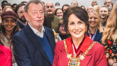 A crowd of people attending the ceremony, including volunteers for the Chilypep charity and its CEO, Lesley Pollard. At the forefront are the Mayor of Sheffield, Councillor Jayne Dunn, and Lord Blunkett of Brightside and Hillsborough.