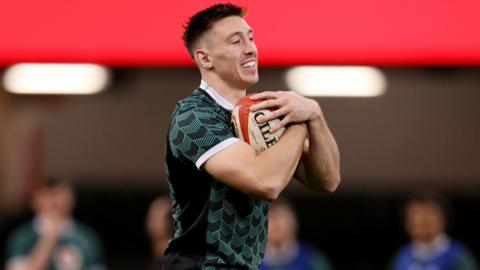 Wales wing Josh Adams catches a ball during a warm-up