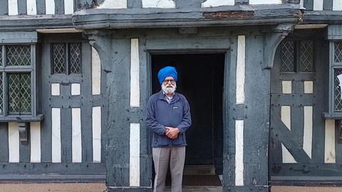 Councillor Charn Singh Padda outside the Oak House Museum.