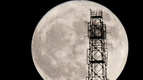 Moon behind power line