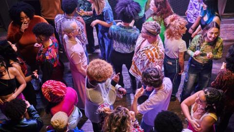 A group of people enjoying an evening out at a music venue