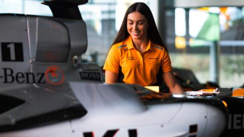 Welsh F1 hopeful Ella Lloyd with McLaren F1 car.