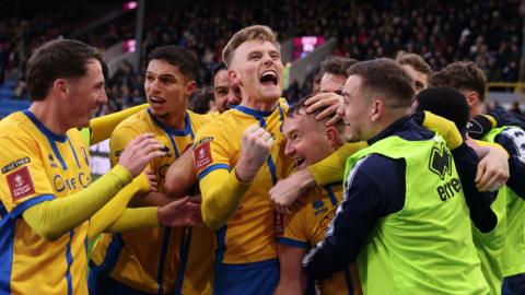  Louis Reed, of Mansfield Town, celebrates with team-mates after scoring against Burnley in the FA Cup