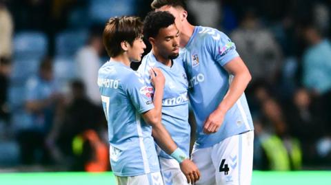 Coventry City's Tatsuhiro Sakamoto and Bobby Thomas console Milan Van Ewijk after the 2-1 defeat to Sunderland in the Championship play-off semi-final first leg