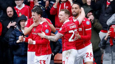 Wrexham goal scorer Nathan Broadhead (second left) celebrates with Lewis O'Brien and Zak Vyner (right)